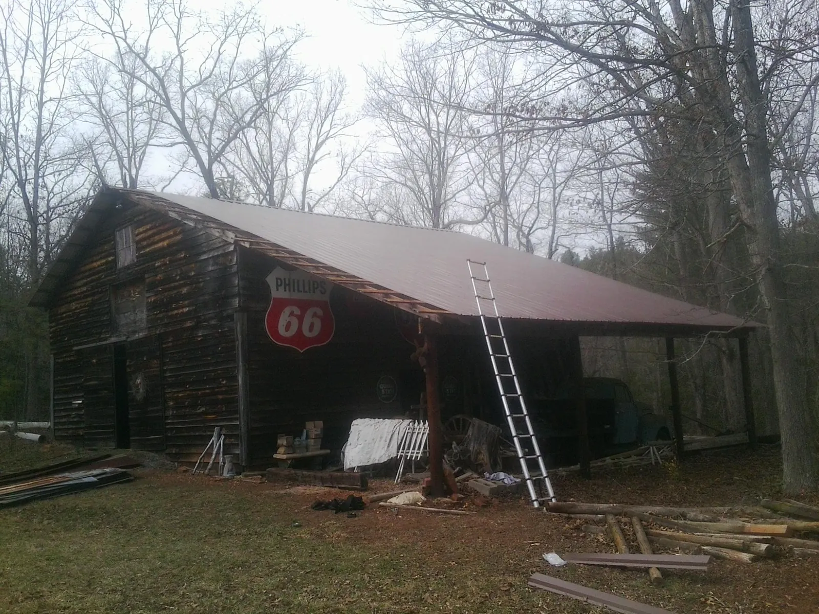New metal roof on an open sided timber barn with a vintage sign in North Bend